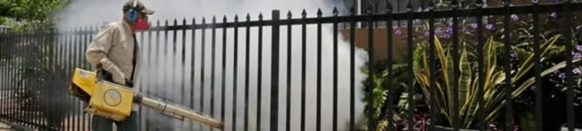 Mosquito control technician fogging a yard perimeter for mosquito reduction in Lincoln, NE